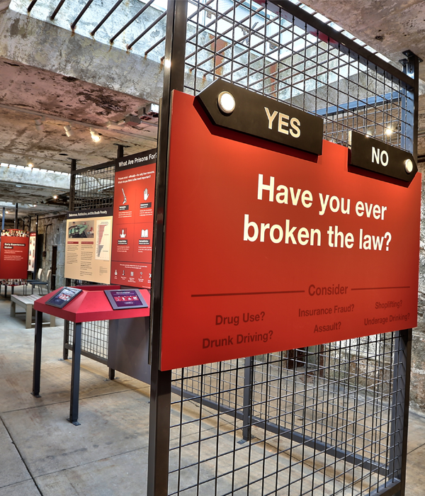 the entrance to Prisons Today with a sign reading "Have you ever broken the law?"